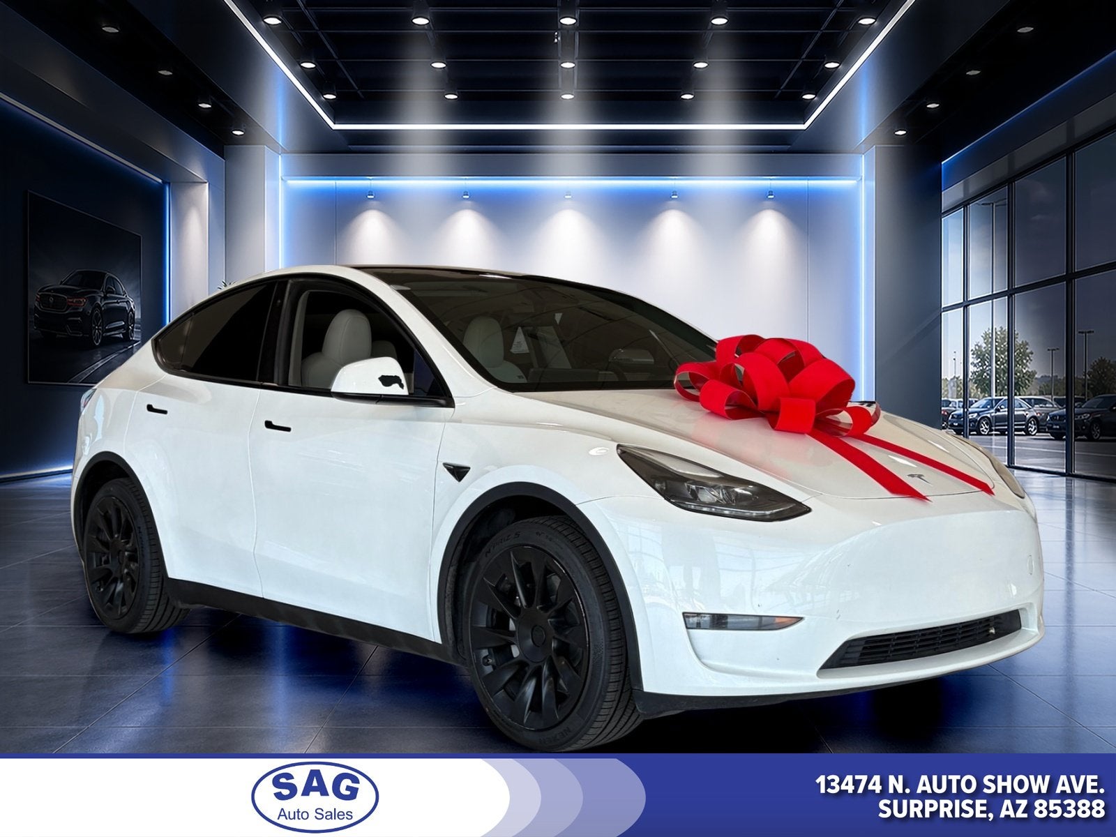 2023 Tesla Model Y Long Range in White — front three-quarter view