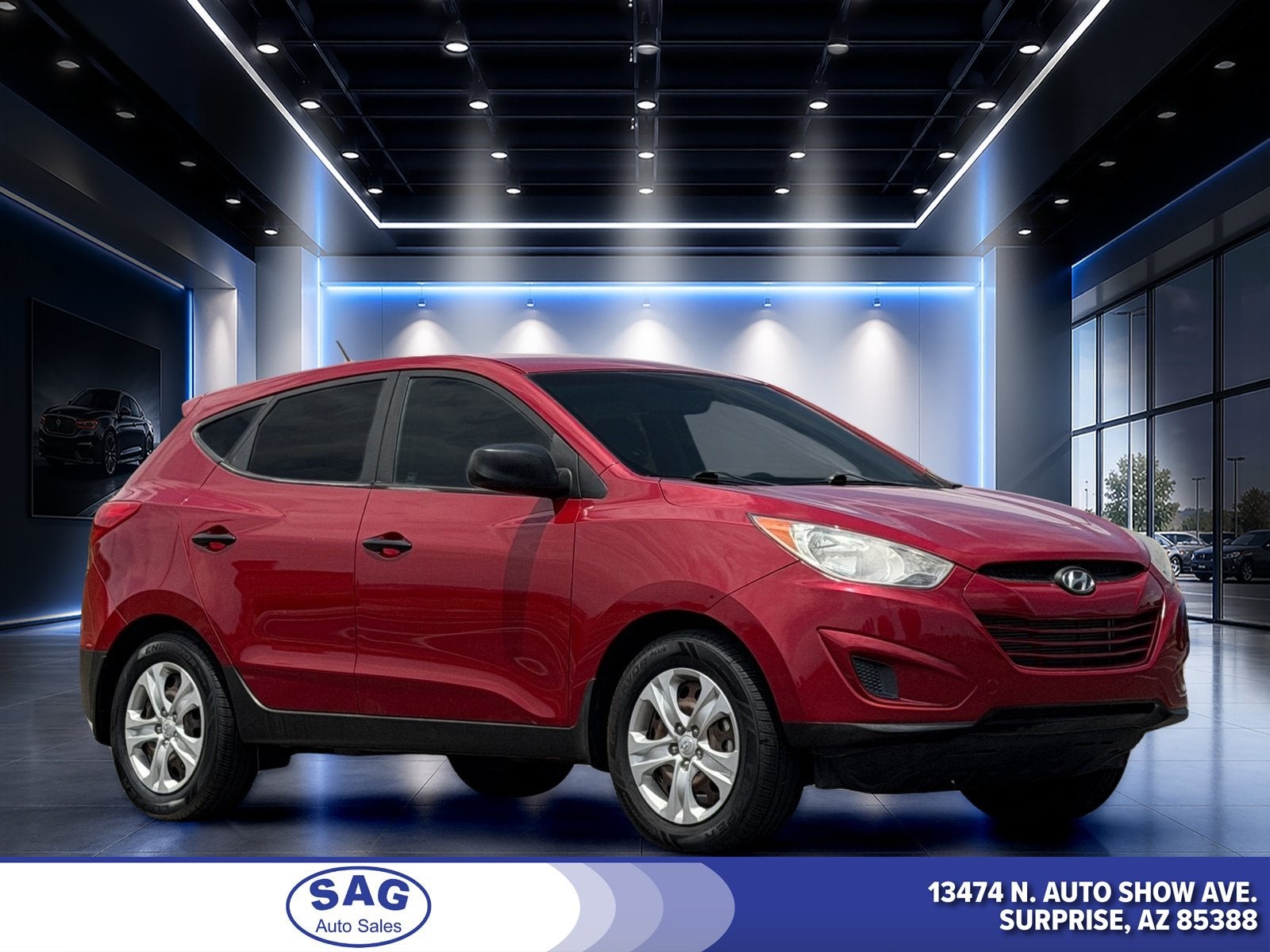 2013 Hyundai Tucson GL in Garnet Red — front three-quarter view